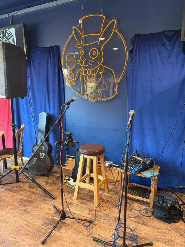 The Rabbit Hole stage set up before the night starts — two microphones, a stool and a mixing desk